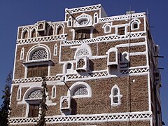 Closer view of a single tower house, showing the plaster decoration