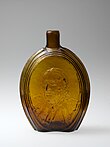 gold flask with face on it