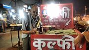 A vendor (kulfiwallah) selling kulfi in India