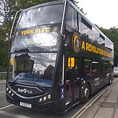 A black double-decker bus with amber coloured writing: "York RLFC" on the front, and "A revolution is coming" on the side