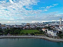 Aerial view of the Esplanade seafront, flanked by the City Hall to the right. The cityscape forms the backdrop.