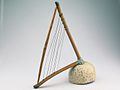 The Loma or belly harp has the appearance of an angle harp or lyre. However it is a frame zither.