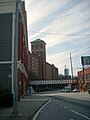 Side view of plant entrance fronting Ponce de Leon Avenue; Sears building (with tower) in background