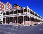 The building is a double storey block in typical Kimberley red brick. The building was designed by White Cooper and erected in 1887 by the company Jones and Cole. Type of site: Commercial Current use: Commercial : Offices. These seven properties, together with the historic buildings thereon, are not only closely associated with the founding and growth of De Beers, the largest diamond mining company in South Africa, but also form the nucleus of the De Beers' conservation areas.