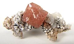 Olmiite crystal with oyelite and calcite. South Africa. Photo by Rob Lavinsky, iRocks.com – CC-BY-SA-3.0.