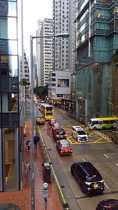 Western end of Queen's Road East on a rainy day, viewed from the overpass. Three Pacific Place is on the right. Hopewell Centre is visible in the distance.