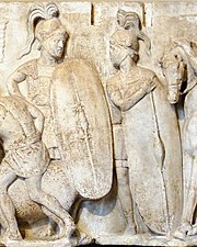 A monochrome relief stele depicting two figures dressed as Roman legionaries