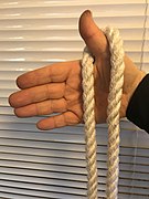 1. The rope hooked by the thumb is let to hang loosely either side.