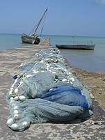 A wharf at Mkoani during the daytime with fishing nets being dried in the sun