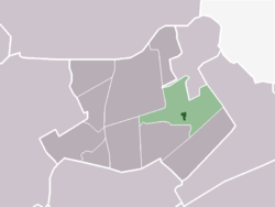 The town centre (dark green) and the statistical district (light green) of Oostwoud in the municipality of Noorder-Koggenland.