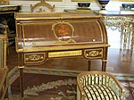 Louis XVI style roll-top desk of Marie-Antoinette; by Jean-Henri Riesener; 1784; oak and pine frame, sycamore, amaranth and rosewood veneer, bronze gilt; 103.6 x 113.4 cm; Louvre[63]