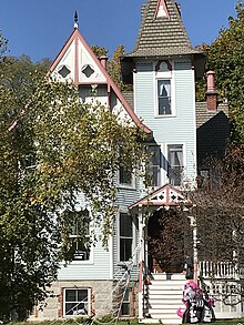 pale blue Victorian house with ornate woodwork