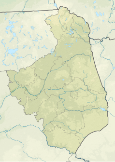 Mapa konturowa województwa podlaskiego, u góry znajduje się owalna plamka nieco zaostrzona i wystająca na lewo w swoim dolnym rogu z opisem „Jezioro Białe Augustowskie”