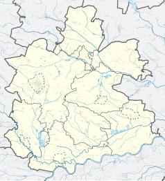 Mapa konturowa powiatu buskiego, po lewej nieco u góry znajduje się punkt z opisem „Mikułowice”