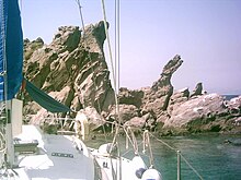 A panorama of pointy rocks taken from a boat