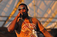 Davis performing in Williamsburg, Brooklyn, on August 29, 2010. He is rapping into his microphone.