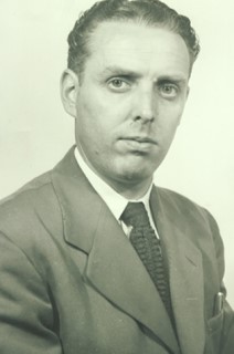 Black and white photo of a middle-aged man dressed in a suit and tie