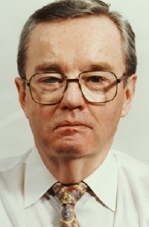 Jim Proudfoot in a white shirt and brown neck tie