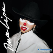 Dua Lipa against a black background wearing a white cowboy shirt with a bolo tie, a black cowboy hat and clown makeup. The singer's name appears on the left in white writing while the song's title appears in the bottom right in blue writing.