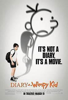 Greg Heffley stands next to a shadow of himself on a wall.