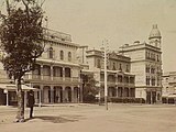 Looking towards Grey Street along Fitzroy Street from Albert Park in 1890, featuring the various buildings that made up the Terminus (now the George) Hotel