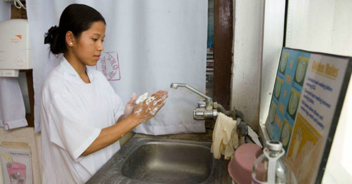 A nurse washing her hands at a hospital