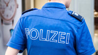 Female Swiss police officer in uniform with equipment, from behind, Lucerne, Switzerland