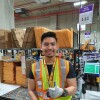 Aung Kaing giving a thumbs up in the fulfillment centre in Singapore