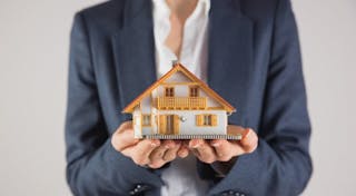 Businesswoman holding miniature model house real estate 房子 房地產