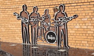 Yekaterinburg, Russia - 21 October 2015: The monument is a silhouettes of the band The Beatleson a brick wall. In front of them 