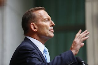 Australian PM Abbott addresses members of the media after a party room meeting at Parliament House in Canberra