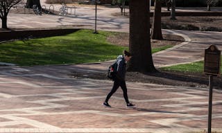 Raleigh, NC/United States- 03/18/2020: A single student walks across the mostly deserted campus of NC State which cancelled face