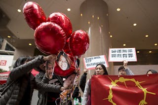 Supporters release balloons with pictures of five detained Chinese female activists during a protest calling for their release i