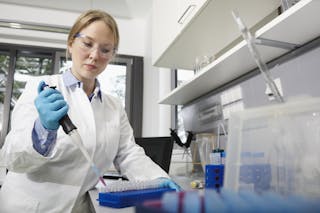 Scientist in lab pipetting