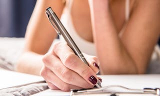 Close-up partial view of teenage girl making notes in notebook — Photo by DmitryPoch