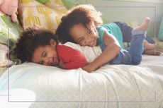 two kids lying and laughing