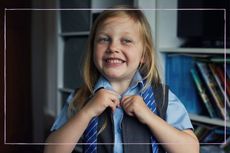 Child putting on school uniform 