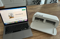 The Cricut Joy Xtra cutting machine beside a laptop open at Design Space, as tested by our Shopping Editor, Heidi Scrimgeour