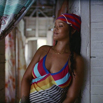 rihanna leaning against a wall