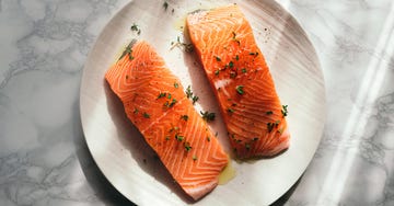 high angle view of salmon slice with herbs on plate on table,egypt