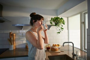 woman drinking from mug in zero waste kitchen