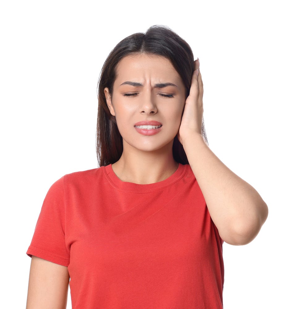 young woman suffering from ear pain on white background