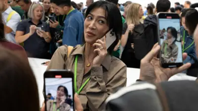 An attendee makes a video with the new iPhone 16 Pro as Apple holds an event at the Steve Jobs Theater on its campus in Cupertino, California, U.S. September 9, 2024