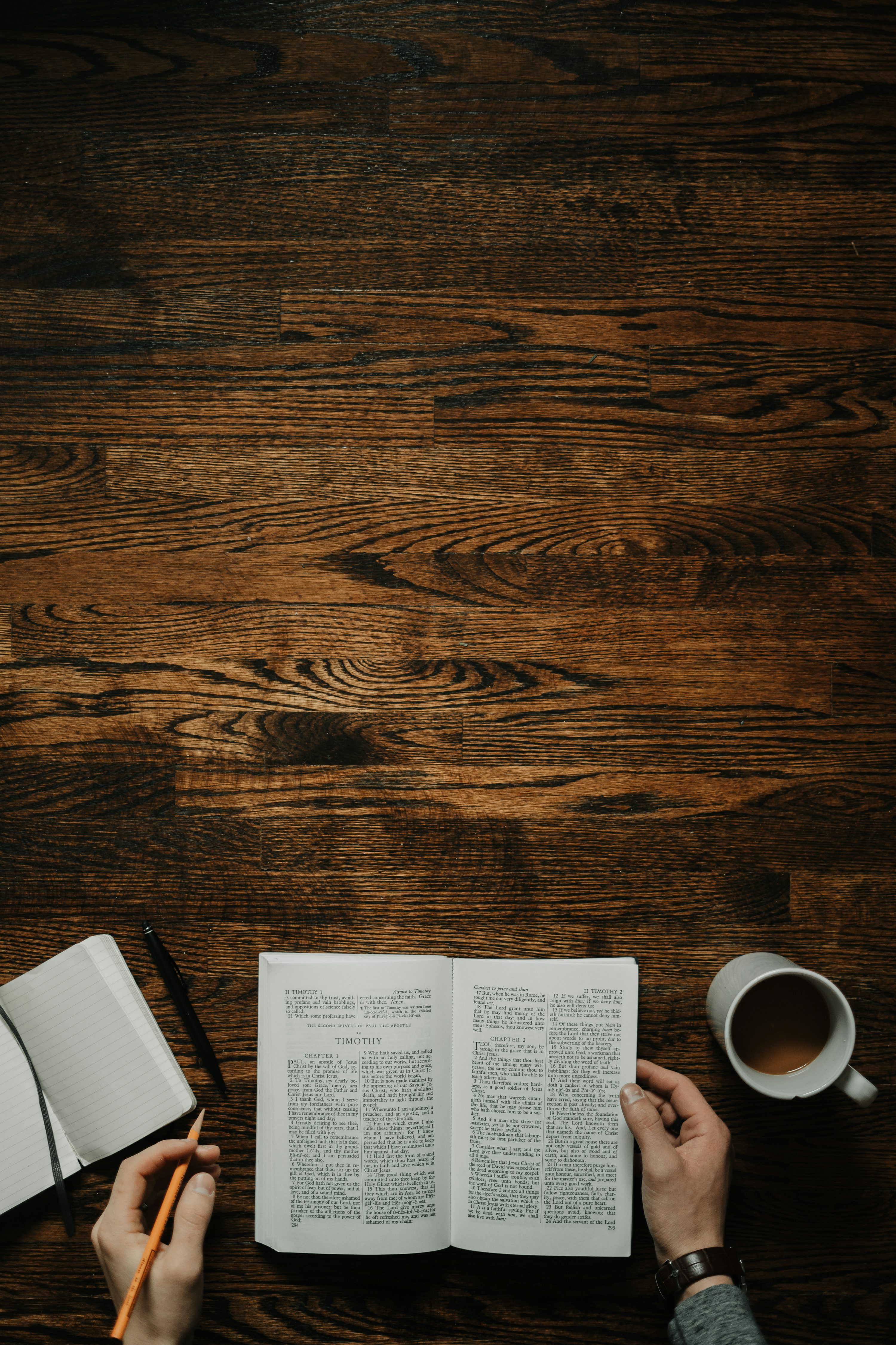 person sitting by the table opening book