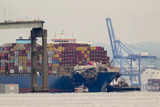 Crashed ship that took down Baltimore bridge refloated, towed from channel