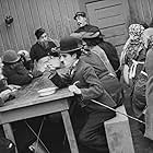 Charles Chaplin, Albert Austin, Eric Campbell, and James T. Kelley in The Immigrant (1917)