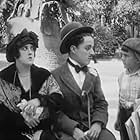 Charles Chaplin, Gordon Griffith, and Mabel Normand in Tillie's Punctured Romance (1914)