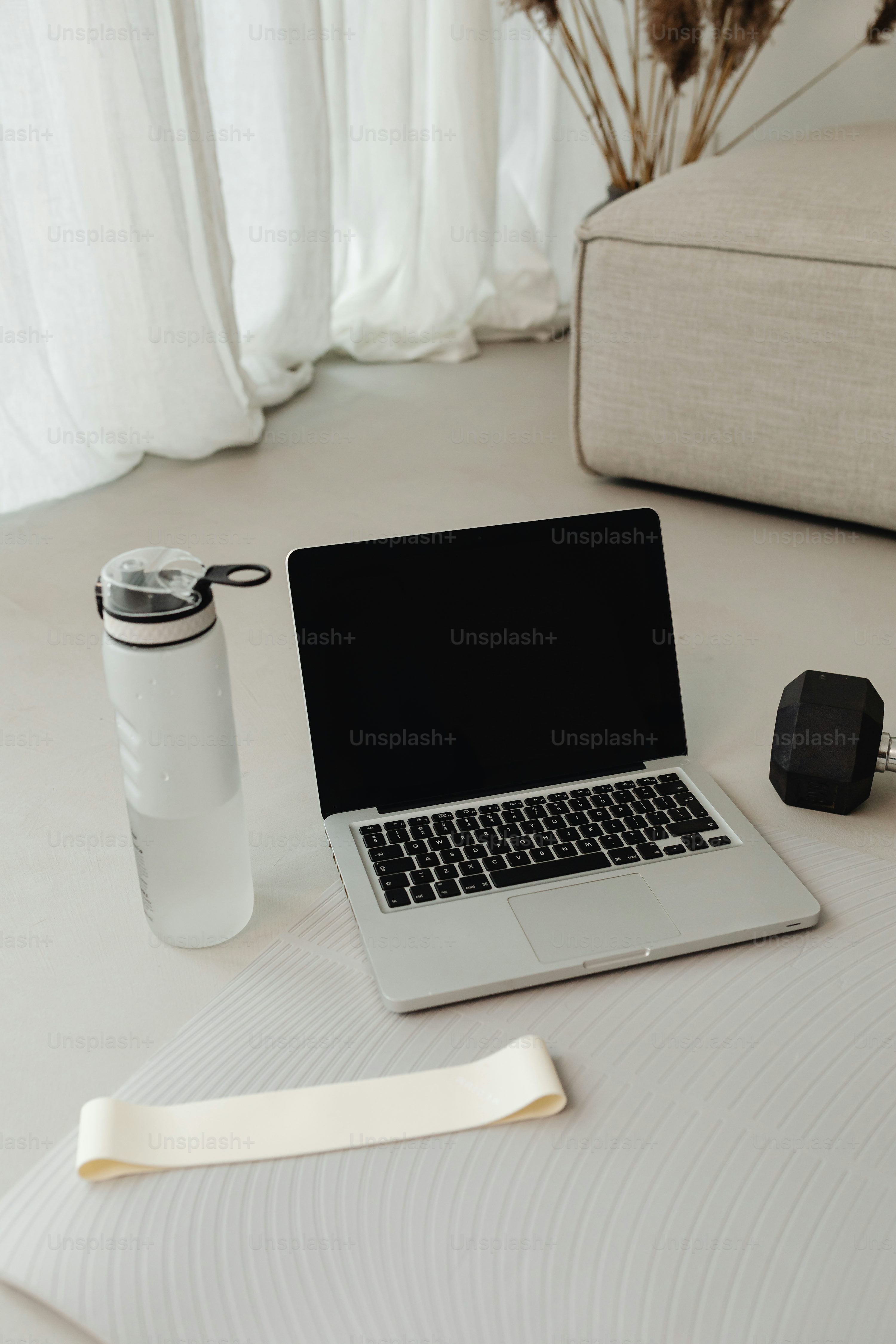 a laptop computer sitting on top of a white table