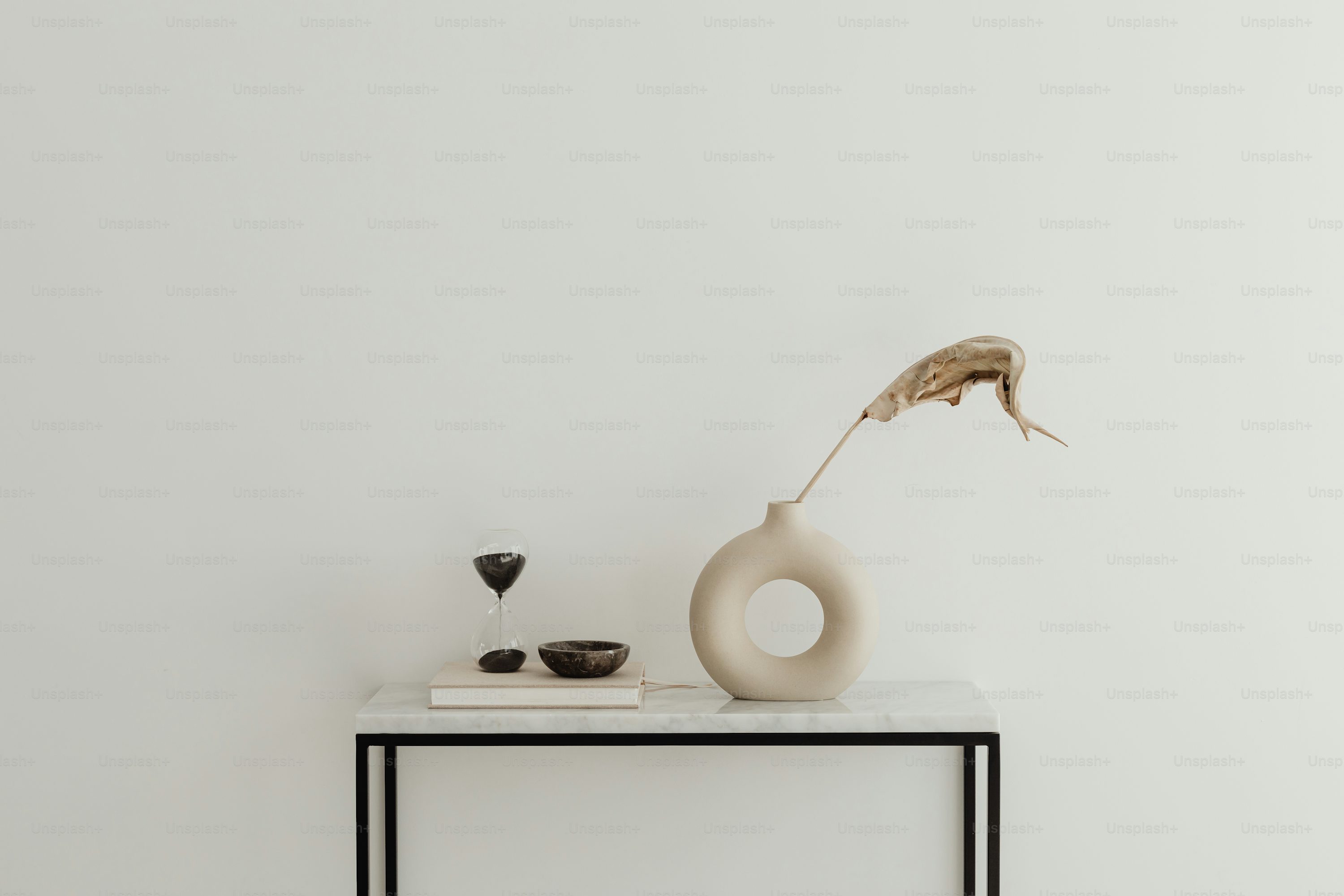 a white vase sitting on top of a table