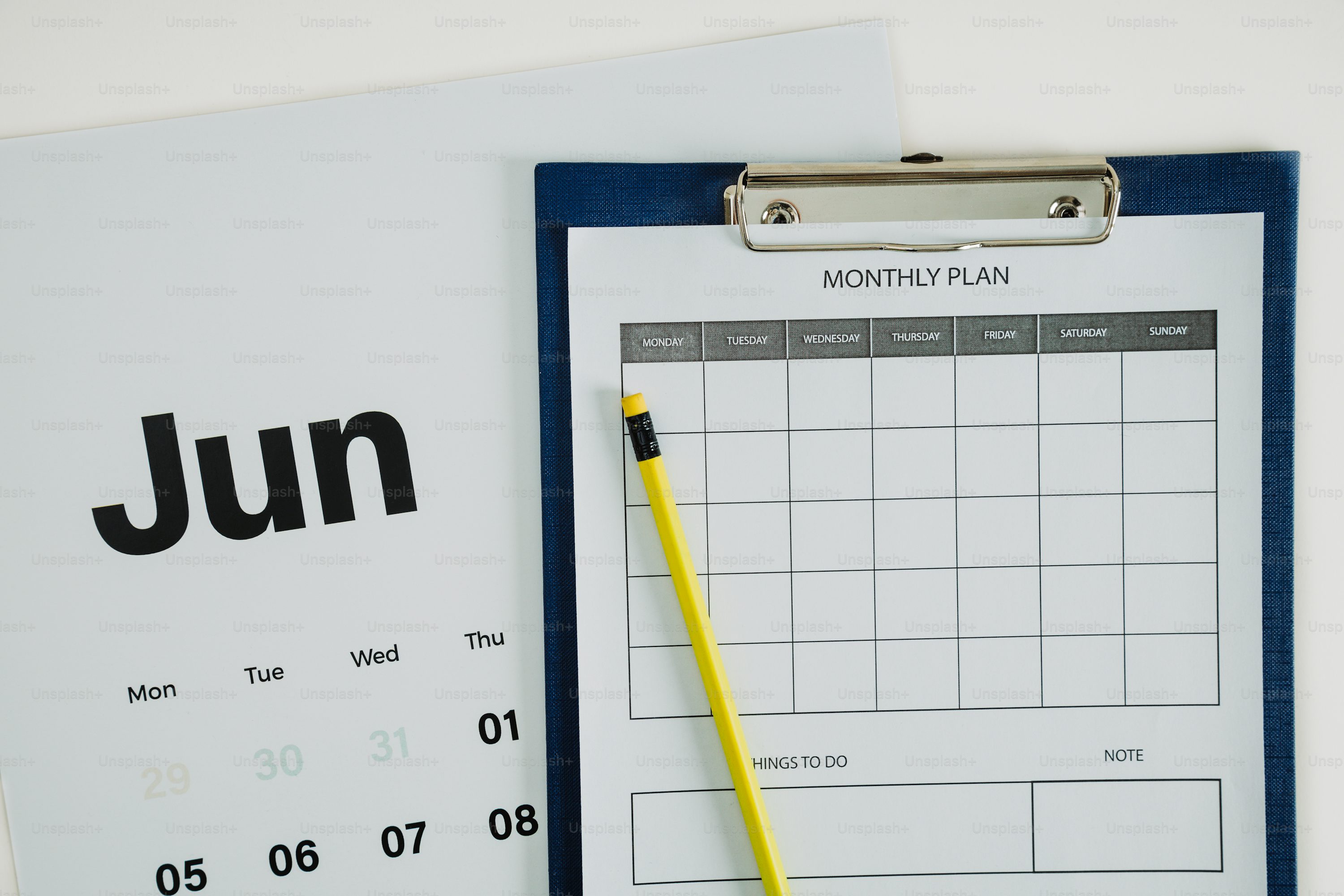 a clipboard with a calendar and a pen on it